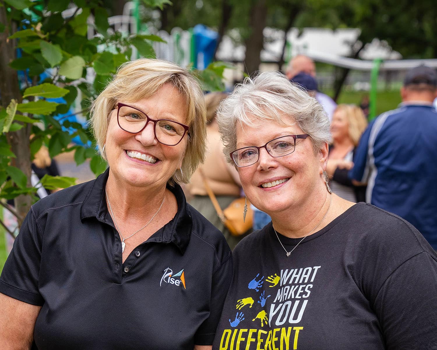 Rise CEO Lynn Noren smiles with a picnic attendee in 2021. Rise prepares for a leadership transition following the announcement of Lynn's 2024 retirement.