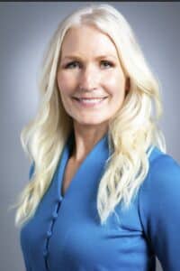 professional headshot of blonde woman in blue button up shirt