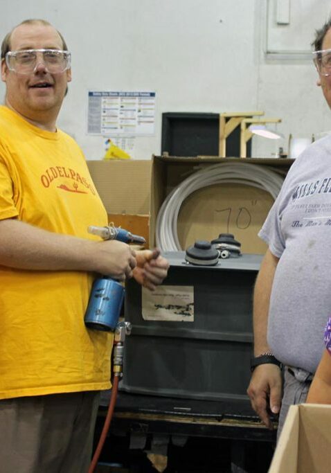 careers supporting people with disabilities group standing working in factory