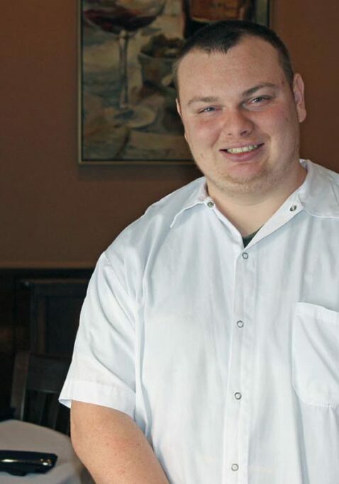 employment services for people with disabilities guy smiling in restaurant