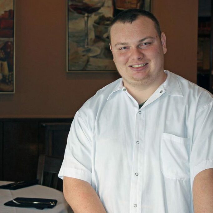 employment services for people with disabilities guy smiling in restaurant