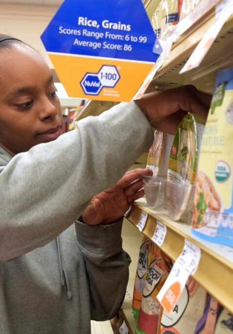 intellectual and developmental disabilities girl restocking shelves