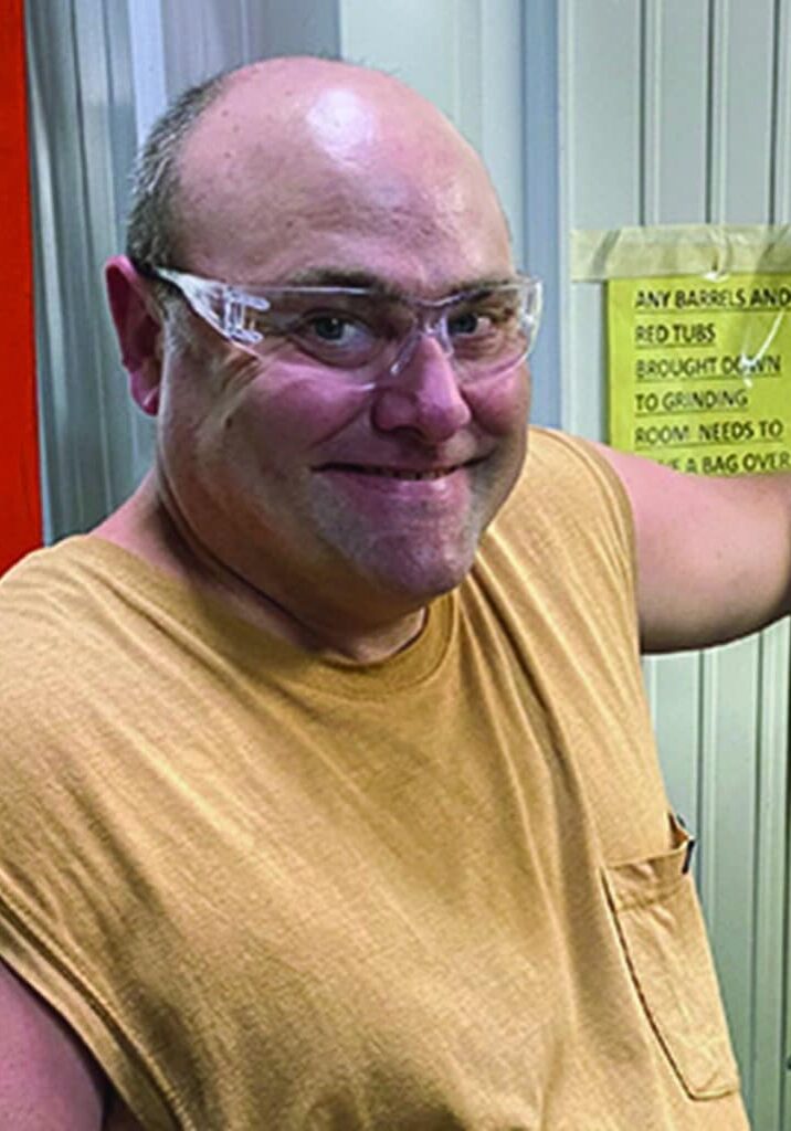 Joey Affolter posed in front of a plastic machine at Westfall Technik in New Richmond, Wisc.