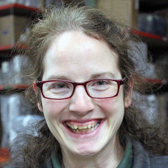 employment success stories minnesota rise lady in glasses standing in warehouse