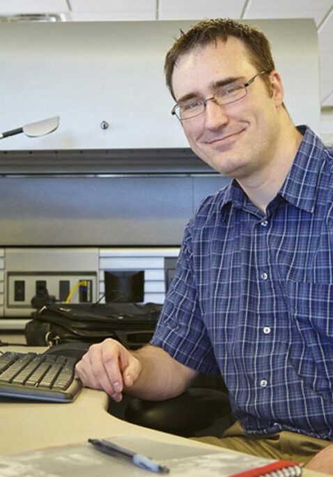 mn employment center man smiling in front of computer