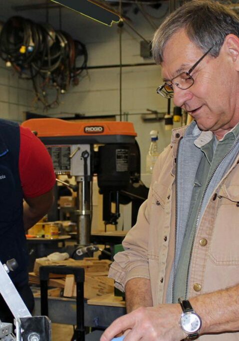 ticket to work program two men standing over machine