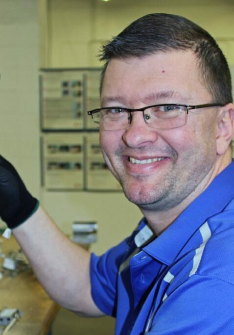 employment support for people with disabilities guy smiling using drill