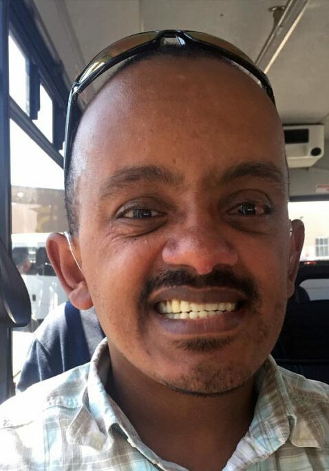 support services for people with intellectual disabilities guy smiling on bus