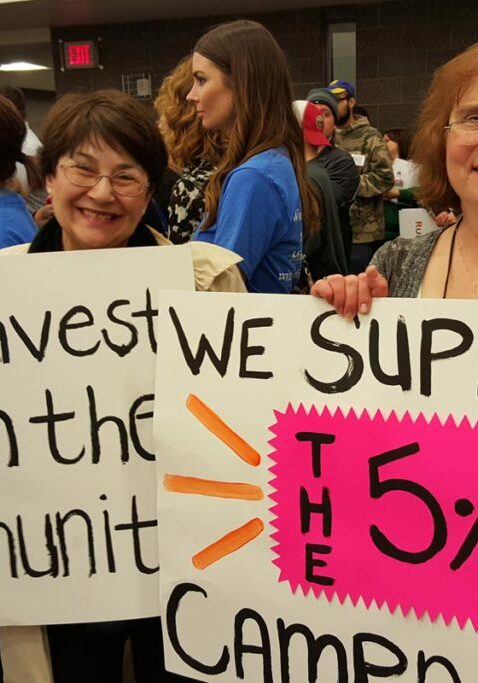 support for people with disabilities ladies holding up signs