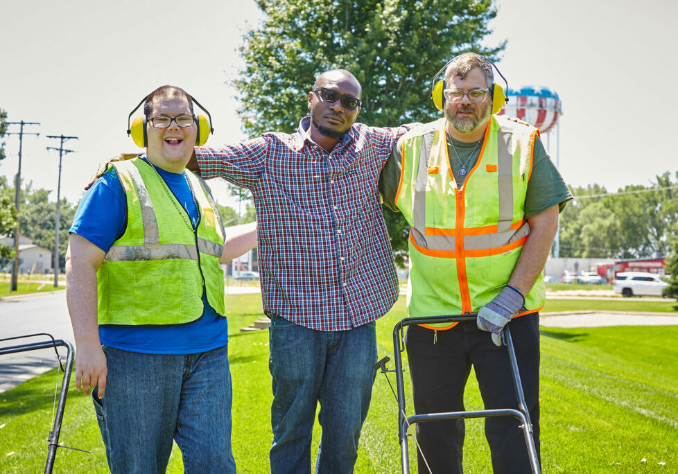 Persons supported by Rise smile for the camera during workday.