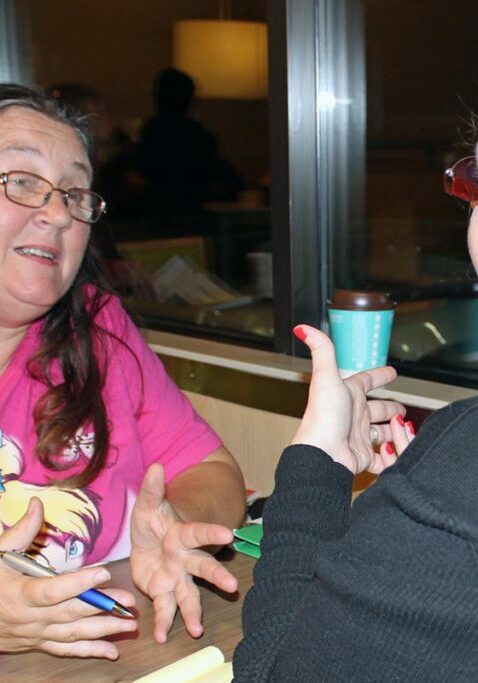 individuals with disabilities two ladies talking at restaurant