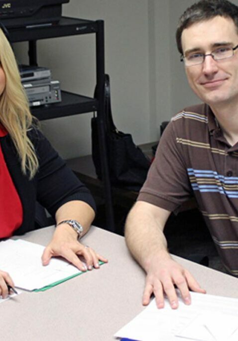 employment services mn team members talking over paper documents