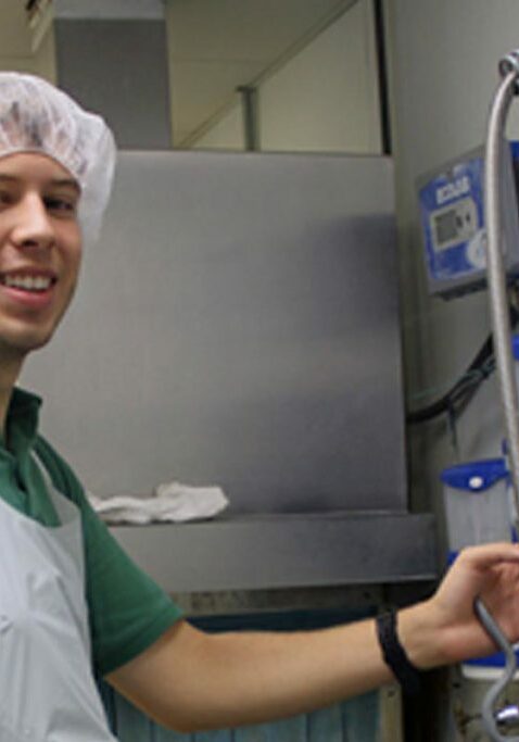 community work programs guy smiling washing dishes