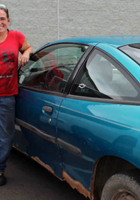 housing support service mpls lady standing by car smiling