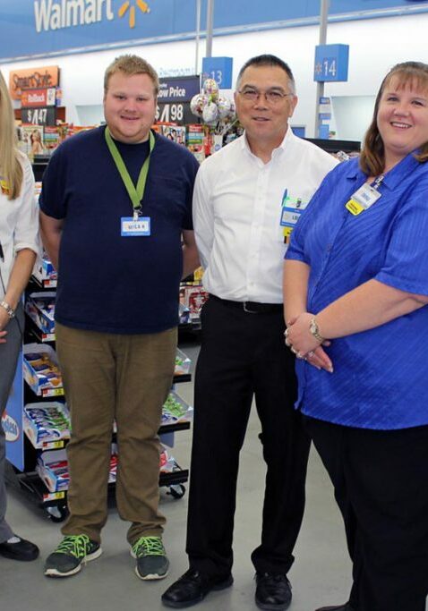 walmart worker smiling in team photo